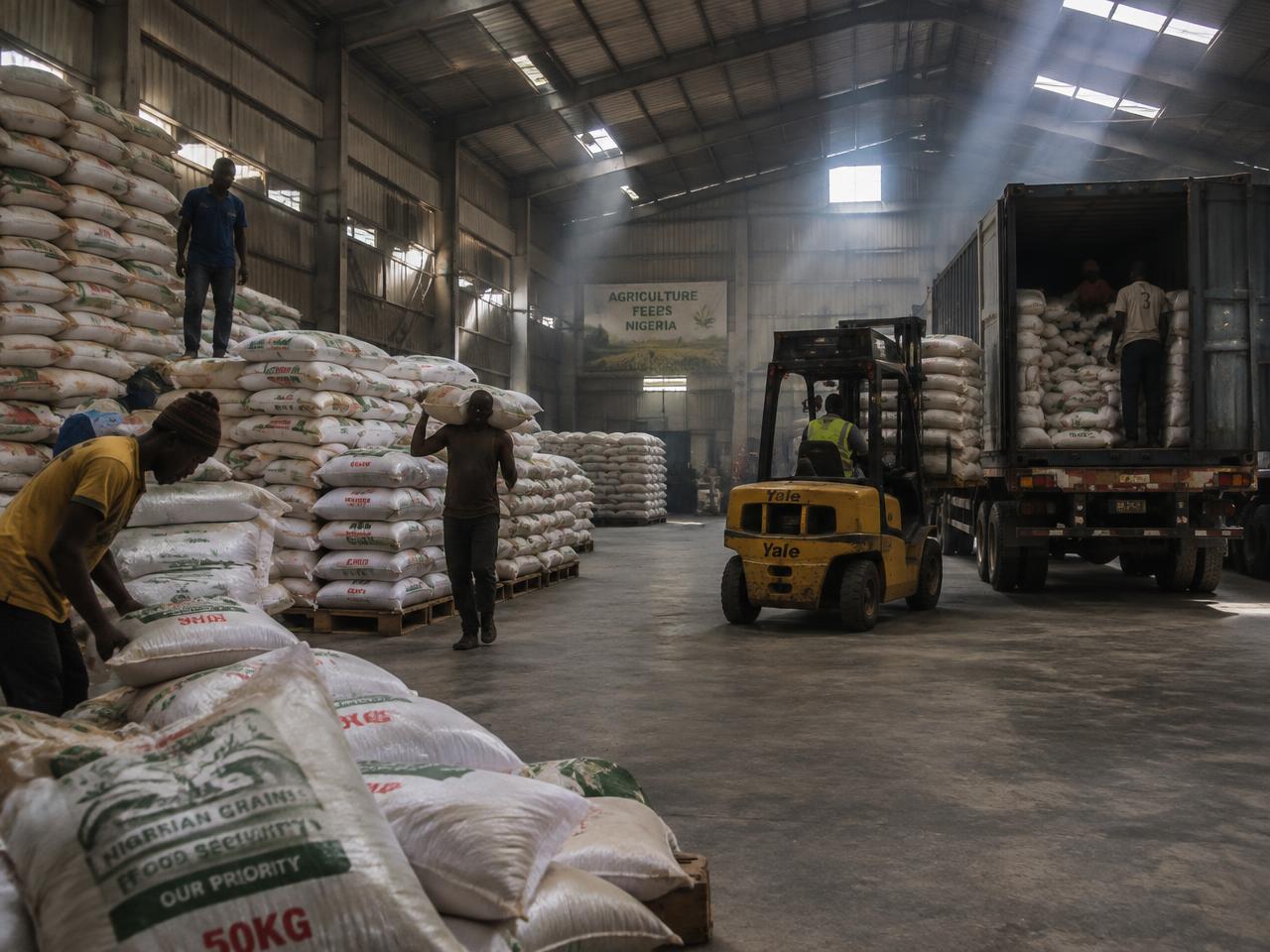 Warehouse workers loading grain for dispatch